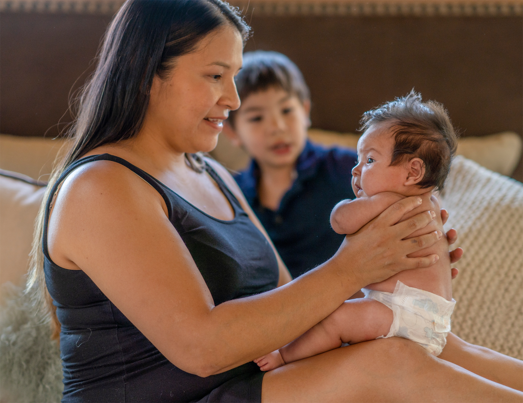 Page Header 2 Woman holding sleeping baby