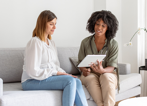 Two women talking on a couch